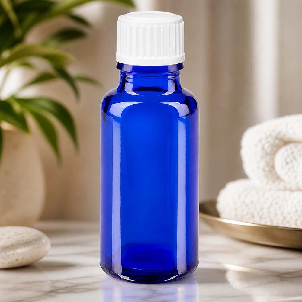 Petit flacon en verre bleu de 20 ml avec bouchon blanc à sécurité enfant pour huiles