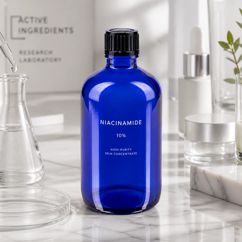 Flacon compte-gouttes bleu de 100 ml STD ApoGlas avec bouchon à vis noir pour concentrés de soins de la peau