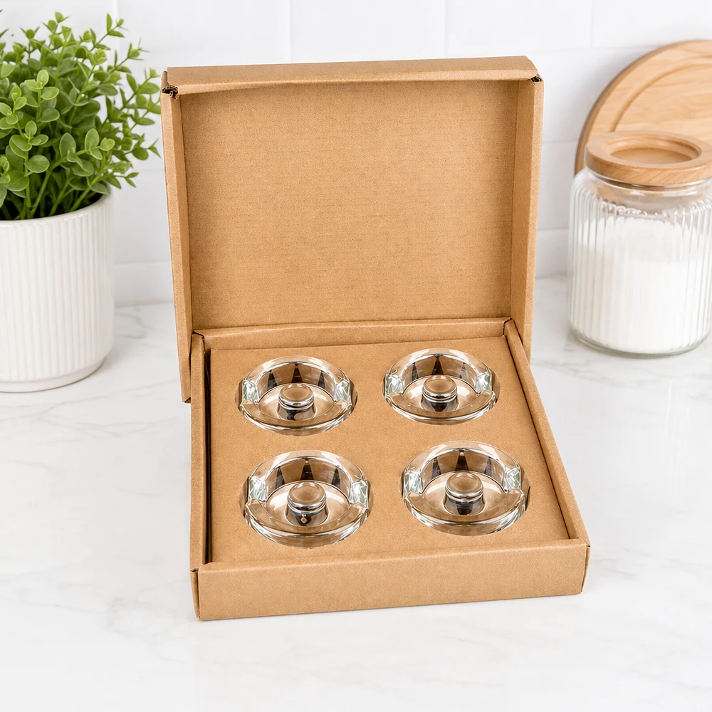 Poids en verre de fermentation UNiTWIST, set de 4, ouvert dans une boîte marron, à côté de la plante et du bocal de stockage