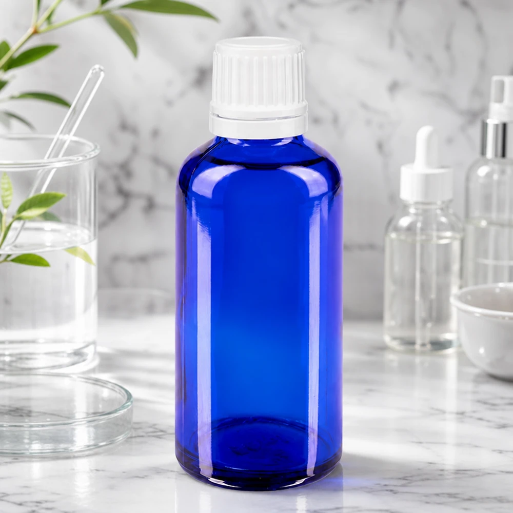 Flacon bleu de 50 ml en verre anti-UV, muni d'un bouchon blanc d'origine, destiné aux teintures et aux essences