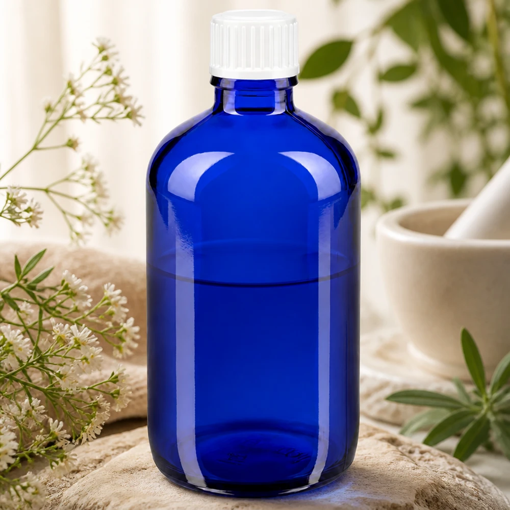 Flacon en verre bleu de 100 ml, de forme cylindrique, muni d'un bouchon de sécurité strié de couleur blanche