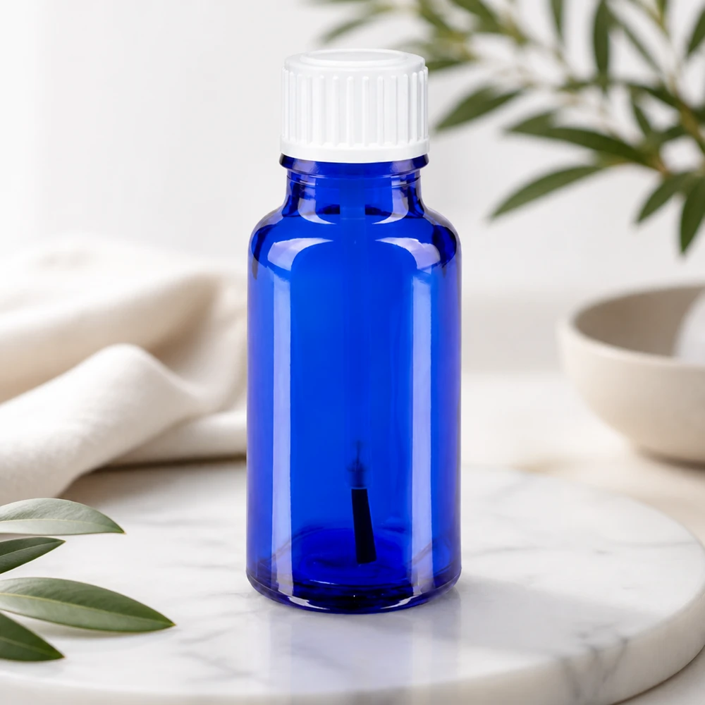 Flacon en verre bleu cobalt de 20 ml avec embout pinceau et bouchon blanc pour produits cosmétiques