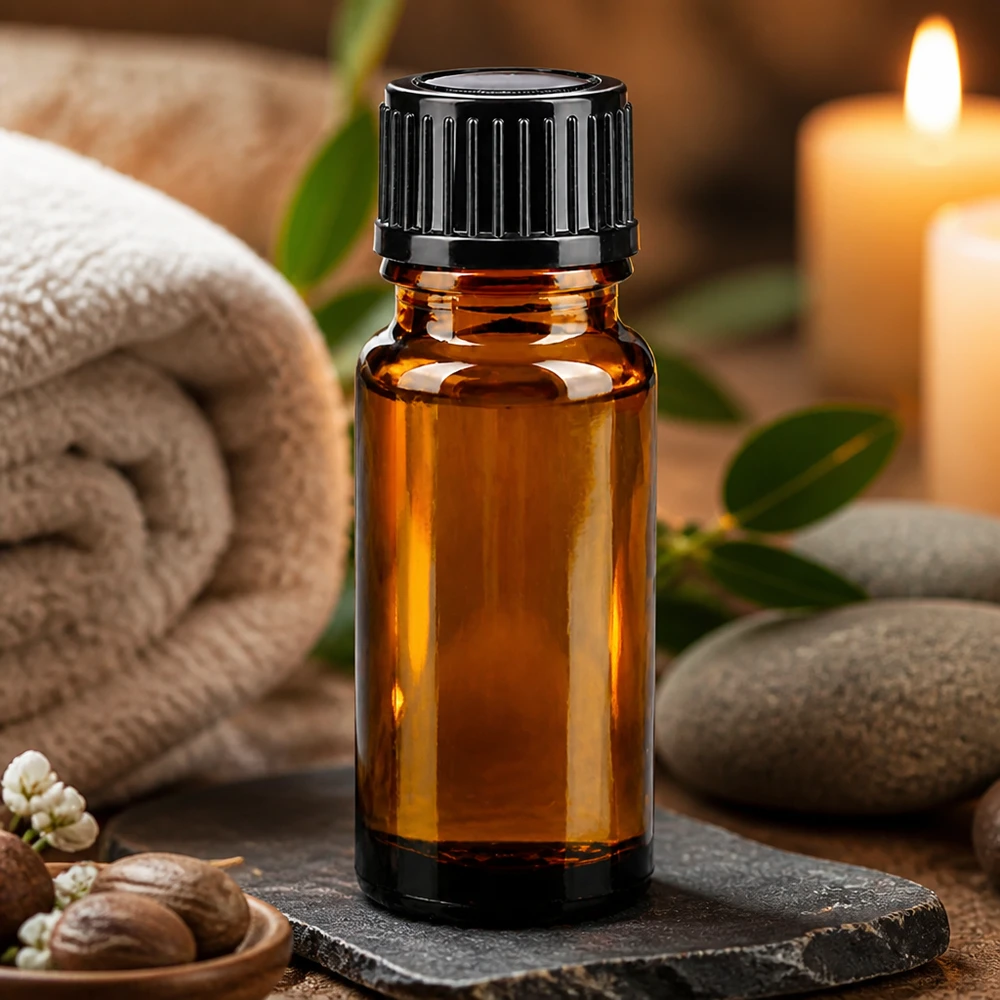 Flacon d'aromathérapie de 10 ml en verre ambré avec bouchon noir, accompagné de pierres de massage et d'une bougie