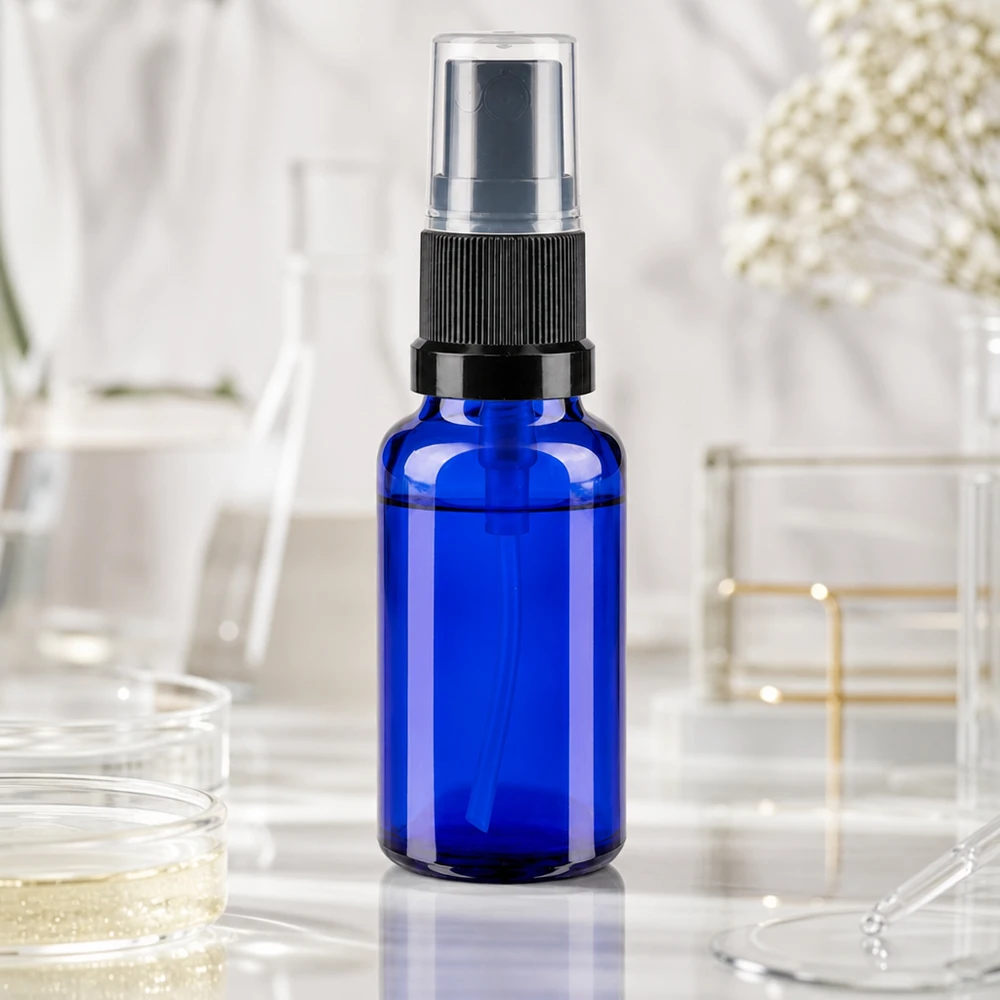 Flacon vaporisateur haut de gamme de 20 ml en verre bleu cobalt avec bouchon-pompe noir