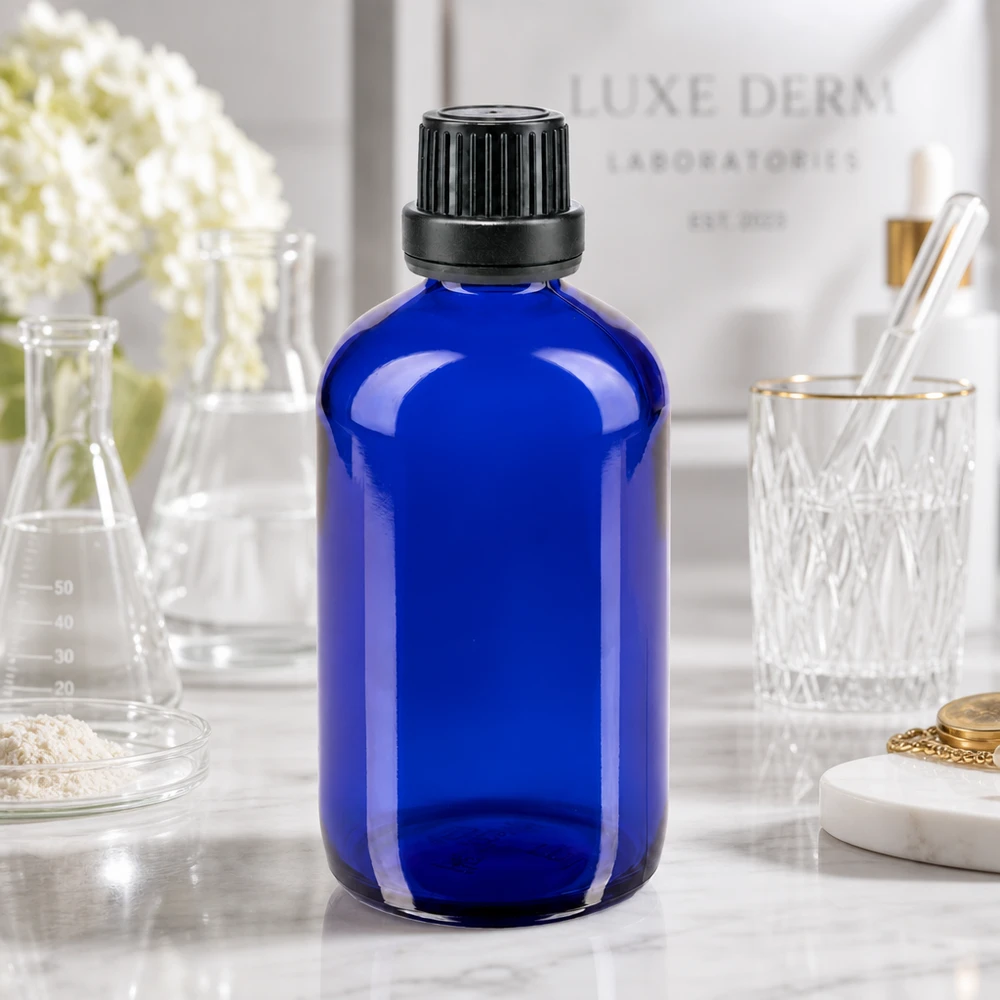 Flacon de pharmacie bleu cobalt de 100 ml en verre anti-UV, muni d'un bouchon à vis nervuré de 11 mm